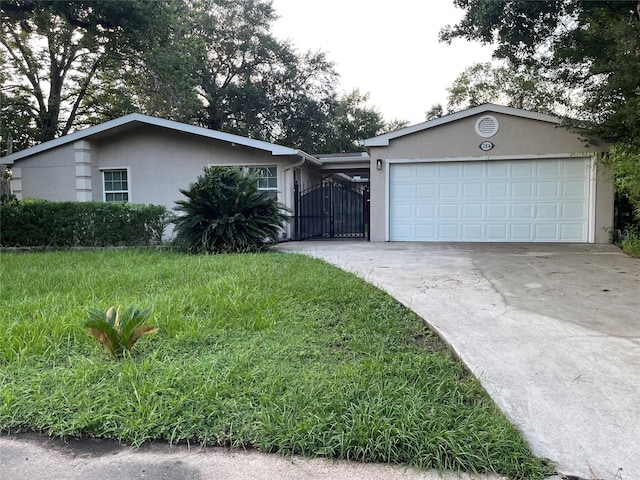 12834 Tosca Ln, Houston, TX 77024 - ranch-style house with stucco siding, driveway, a garage, a gate, and a front yard