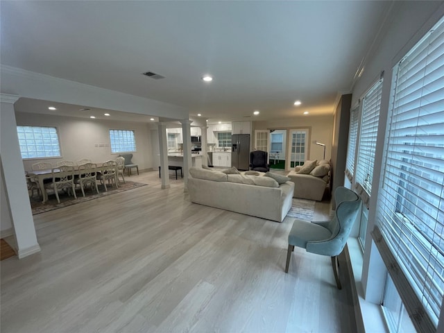 12834 Tosca Ln, Houston, TX 77024 - living room with ornamental molding, decorative columns, recessed lighting, and light wood-style floors