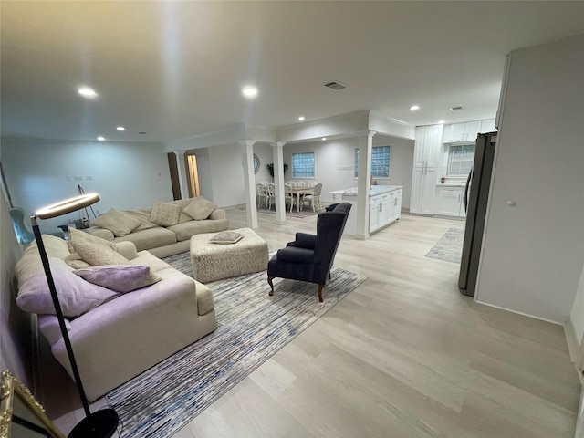 12834 Tosca Ln, Houston, TX 77024 - living area featuring decorative columns, light wood finished floors, and recessed lighting