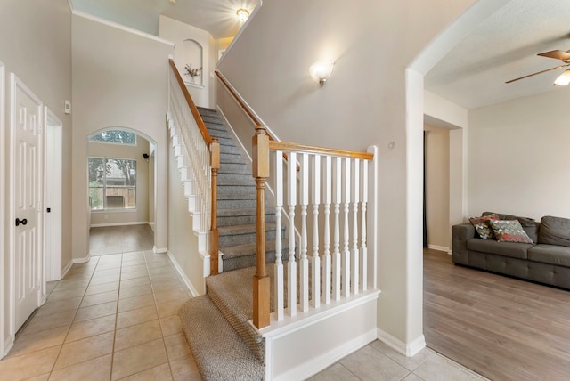 3202 Stoneydale Ln, Spring, TX 77388 - stairs featuring tile patterned floors, a ceiling fan, and arched walkways