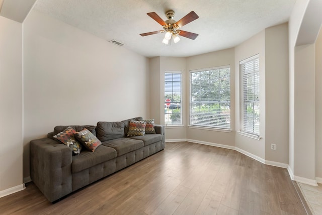 3202 Stoneydale Ln, Spring, TX 77388 - living area featuring healthy amount of natural light, a ceiling fan, wood finished floors, and a textured ceiling