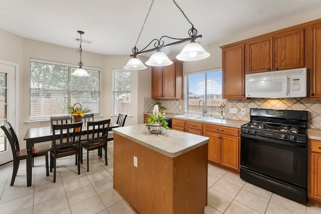 3202 Stoneydale Ln, Spring, TX 77388 - kitchen with white microwave, black gas stove, light countertops, a kitchen island, and decorative backsplash