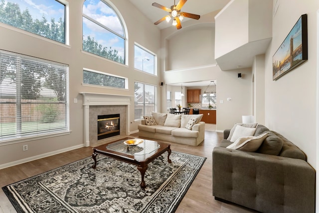 3202 Stoneydale Ln, Spring, TX 77388 - living area with ceiling fan, high vaulted ceiling, a tile fireplace, and light wood-style flooring