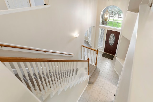 3202 Stoneydale Ln, Spring, TX 77388 - foyer with light tile patterned flooring, stairs, a chandelier, and arched walkways