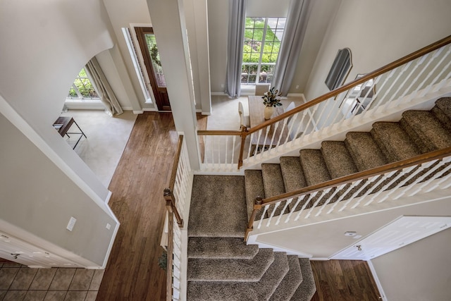 16407 Bogan Flats Ct, Houston, TX 77095 - stairs featuring plenty of natural light, a high ceiling, and wood finished floors