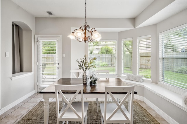 16407 Bogan Flats Ct, Houston, TX 77095 - dining space with light tile patterned floors, a chandelier, and arched walkways