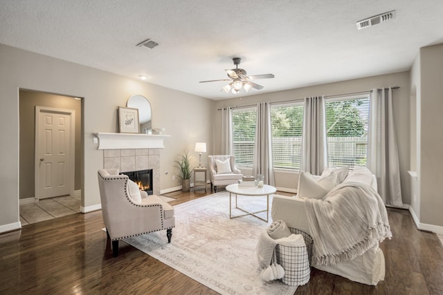 16407 Bogan Flats Ct, Houston, TX 77095 - living room featuring a tiled fireplace, wood finished floors, and a ceiling fan