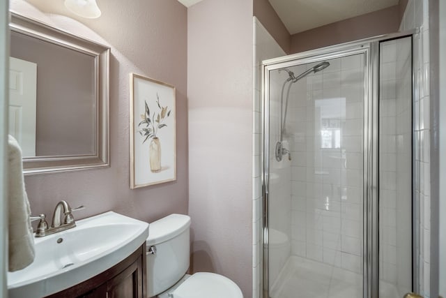 16407 Bogan Flats Ct, Houston, TX 77095 - bathroom with vanity, a stall shower, and a textured wall