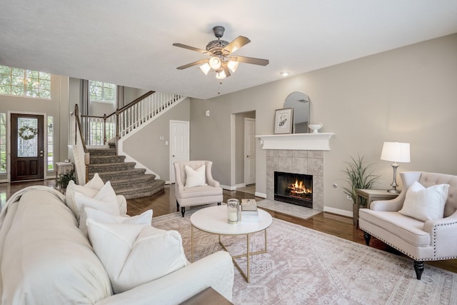 16407 Bogan Flats Ct, Houston, TX 77095 - living room with a tiled fireplace, wood finished floors, stairway, and ceiling fan