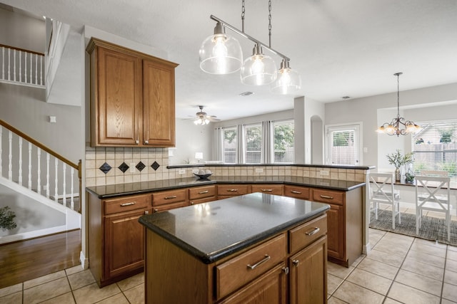 16407 Bogan Flats Ct, Houston, TX 77095 - kitchen featuring brown cabinetry, plenty of natural light, and a peninsula