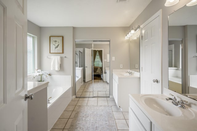 16407 Bogan Flats Ct, Houston, TX 77095 - ensuite bathroom with a bath, two vanities, and tile patterned flooring