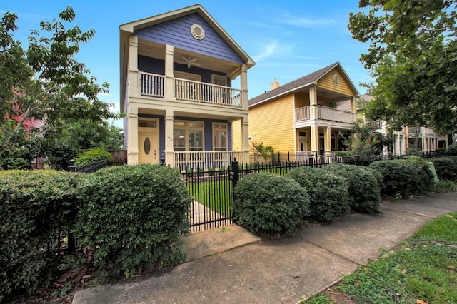 4734 Cashel Glen Dr, Houston, TX 77069 - view of front of home featuring a balcony, a fenced front yard, a ceiling fan, and a gate