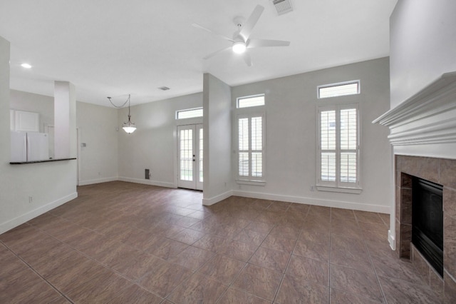 4734 Cashel Glen Dr, Houston, TX 77069 - unfurnished living room featuring a tile fireplace, ceiling fan, and dark tile patterned floors