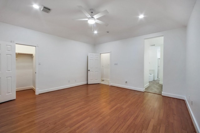 4734 Cashel Glen Dr, Houston, TX 77069 - unfurnished bedroom featuring light wood-style flooring, ensuite bath, a walk in closet, and a ceiling fan