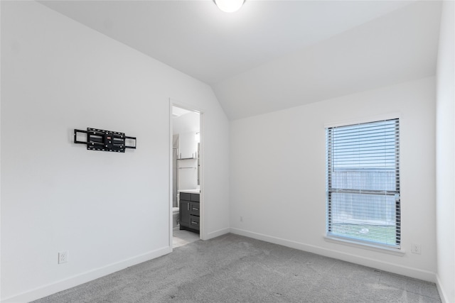 14811 Opossum Branch Ct, Cypress, TX 77433 - unfurnished bedroom featuring light carpet, vaulted ceiling, and ensuite bathroom