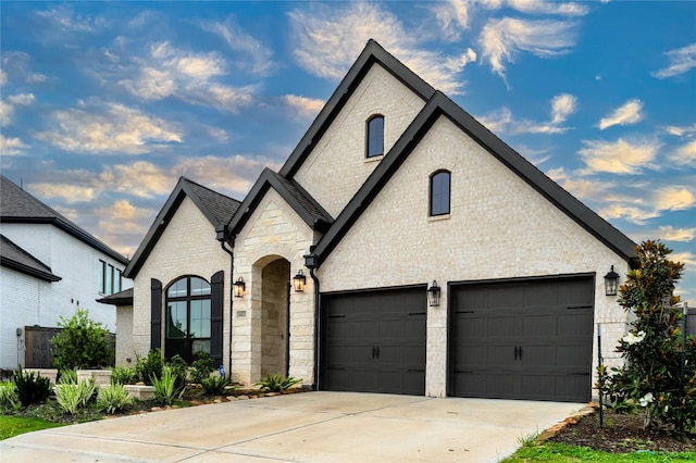 14811 Opossum Branch Ct, Cypress, TX 77433 - french country style house featuring concrete driveway, stone siding, brick siding, and a garage