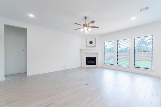 14811 Opossum Branch Ct, Cypress, TX 77433 - unfurnished living room featuring ceiling fan, light wood finished floors, a fireplace, and recessed lighting