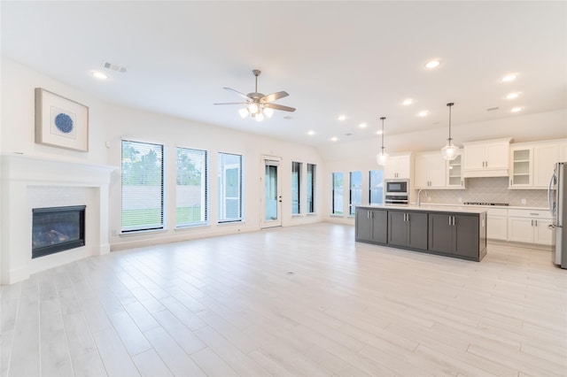 14811 Opossum Branch Ct, Cypress, TX 77433 - kitchen with appliances with stainless steel finishes, open floor plan, plenty of natural light, ceiling fan, and recessed lighting