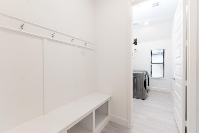 14811 Opossum Branch Ct, Cypress, TX 77433 - mudroom featuring washing machine and clothes dryer and light wood-type flooring