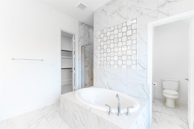 14811 Opossum Branch Ct, Cypress, TX 77433 - bathroom with marble look tile flooring, a garden tub, and a walk in closet