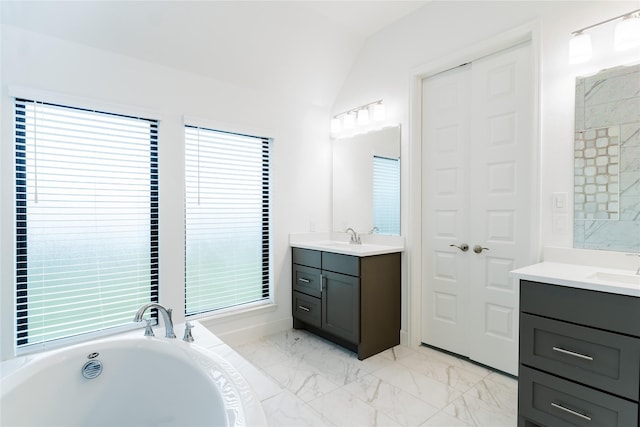 14811 Opossum Branch Ct, Cypress, TX 77433 - full bathroom with two vanities, a garden tub, vaulted ceiling, and marble look tile flooring