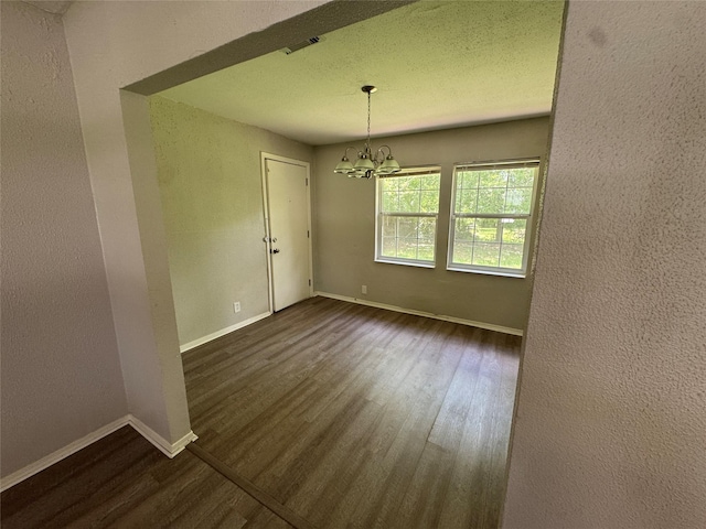 2222 8th St, Houston, TX 77547 - spare room featuring dark wood-type flooring and a chandelier