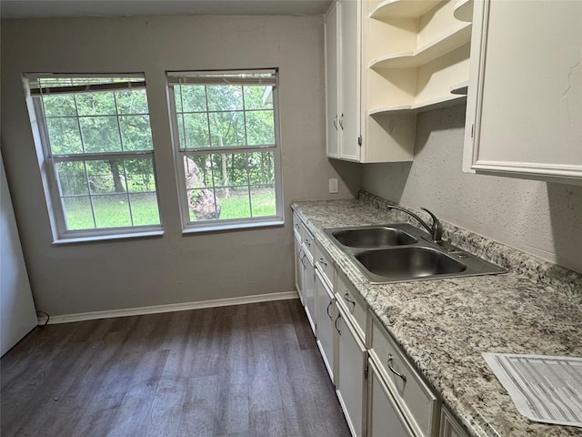2222 8th St, Houston, TX 77547 - kitchen with dark wood-type flooring, white cabinets, plenty of natural light, and open shelves