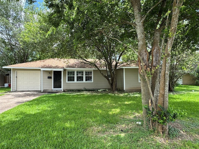 2222 8th St, Houston, TX 77547 - ranch-style home featuring concrete driveway, a garage, and a front lawn