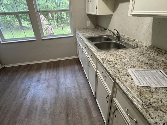 2222 8th St, Houston, TX 77547 - kitchen with dark wood-style flooring and white cabinets