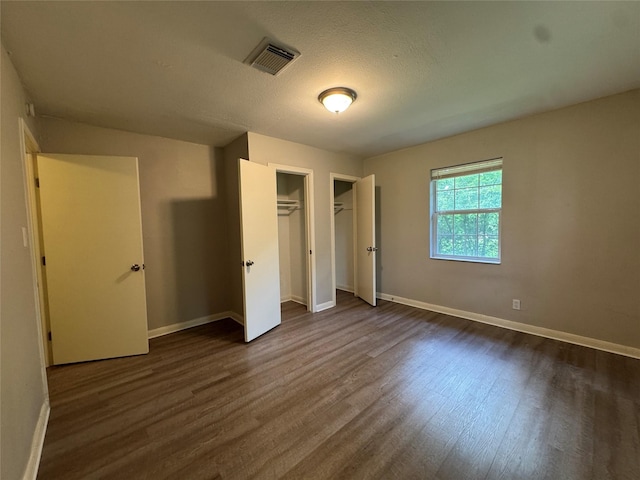 2222 8th St, Houston, TX 77547 - unfurnished bedroom featuring dark wood-type flooring and baseboards