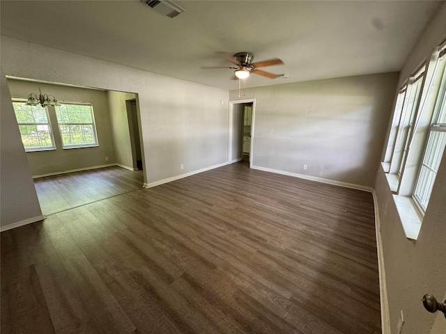 2222 8th St, Houston, TX 77547 - empty room featuring dark wood-type flooring, a ceiling fan, and a chandelier