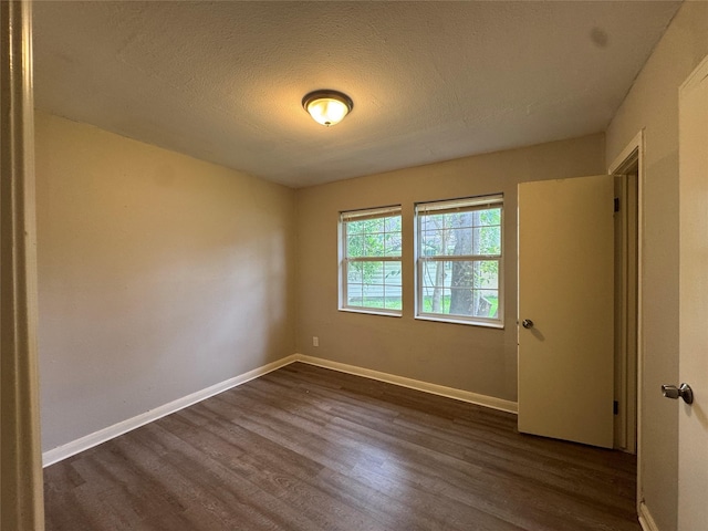 2222 8th St, Houston, TX 77547 - empty room featuring dark wood-style flooring and a textured ceiling