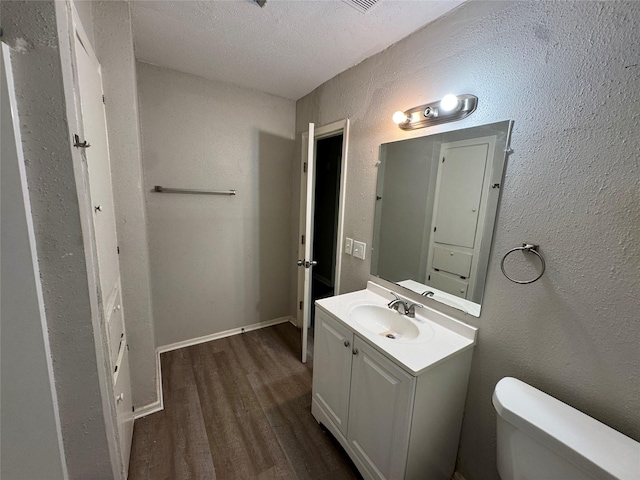 2222 8th St, Houston, TX 77547 - bathroom with wood finished floors, vanity, a textured ceiling, and a textured wall
