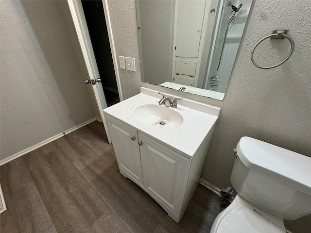 2222 8th St, Houston, TX 77547 - bathroom with vanity, wood finished floors, and a textured wall