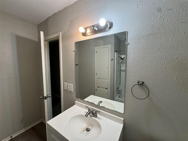 2222 8th St, Houston, TX 77547 - full bath featuring bathing tub / shower combination, vanity, and a textured wall