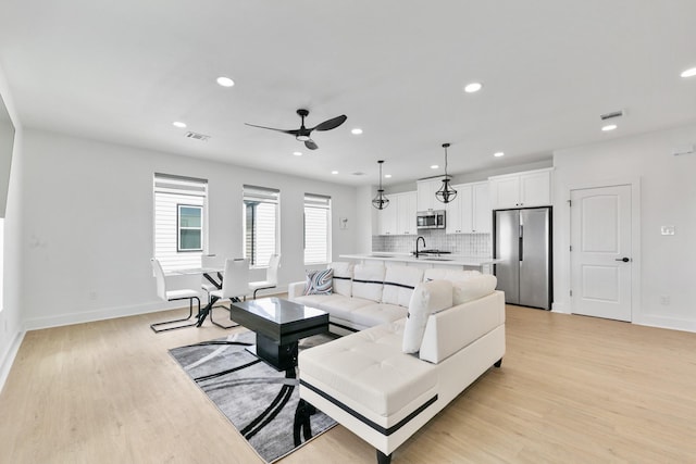 104 E 44th St Unit A, Houston, TX 77018 - living room with light wood-style flooring, recessed lighting, and a ceiling fan