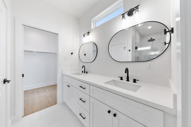 104 E 44th St Unit A, Houston, TX 77018 - bathroom with double vanity, walk in shower, a walk in closet, and tile patterned floors