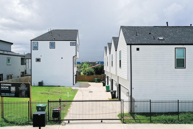 104 E 44th St Unit A, Houston, TX 77018 - view of property exterior featuring driveway, a garage, a fenced front yard, and a gate