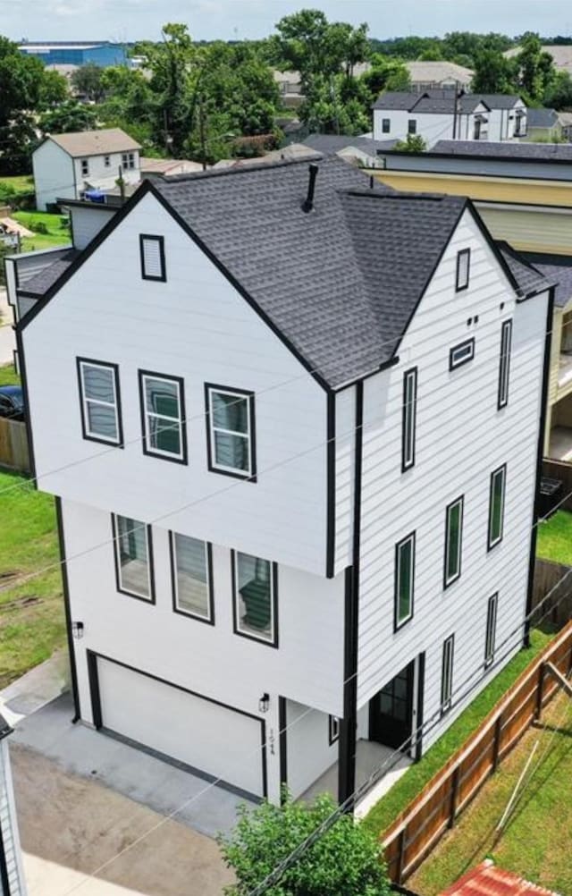 104 E 44th St Unit A, Houston, TX 77018 - view of front of home with a shingled roof, an attached garage, and driveway