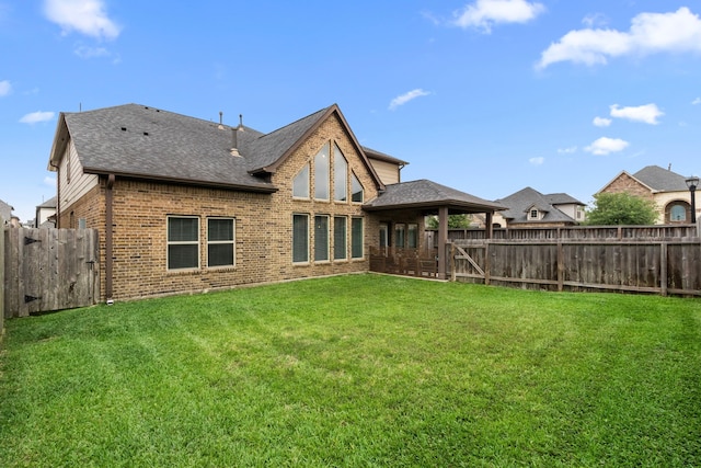 6303 Grand Drift Ct, Katy, TX 77494 - rear view of house with brick siding, a fenced backyard, a shingled roof, and a gate