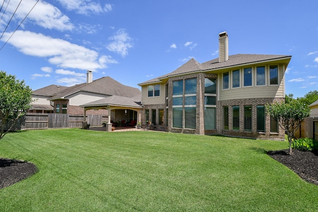 8706 Stowe Creek Ln, Missouri City, TX 77459 - rear view of house featuring brick siding, a fenced backyard, a patio, and a chimney