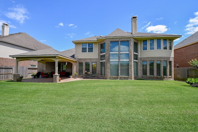 8706 Stowe Creek Ln, Missouri City, TX 77459 - back of house featuring a patio, brick siding, a chimney, and a shingled roof