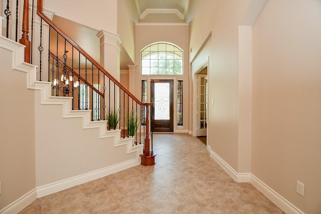 8706 Stowe Creek Ln, Missouri City, TX 77459 - entrance foyer with a high ceiling, stairs, ornamental molding, and light tile patterned flooring