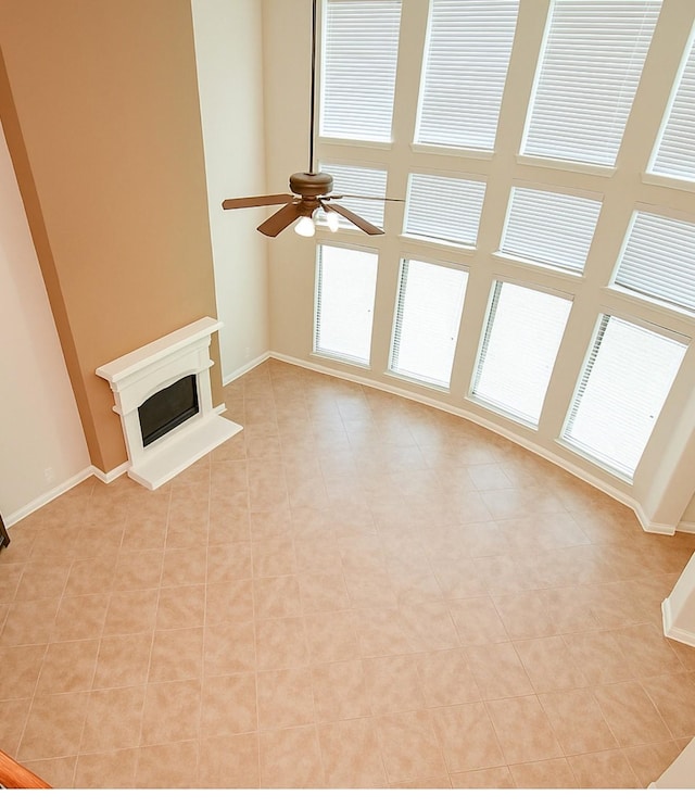 8706 Stowe Creek Ln, Missouri City, TX 77459 - unfurnished living room with a ceiling fan and a fireplace with raised hearth