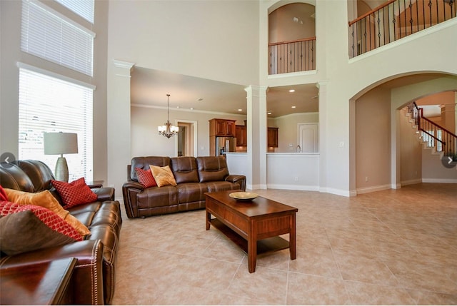 8706 Stowe Creek Ln, Missouri City, TX 77459 - living area with a high ceiling, light tile patterned flooring, arched walkways, stairs, and a chandelier