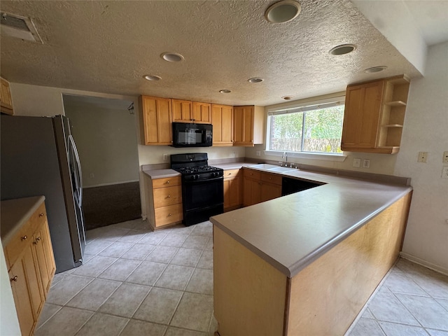 3 Ridgeline Ct, The Woodlands, TX 77381 - kitchen with black appliances, a peninsula, light tile patterned floors, a textured ceiling, and recessed lighting
