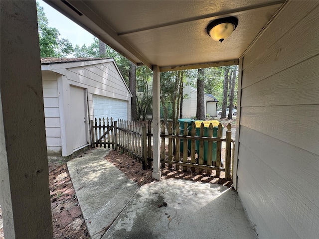 3 Ridgeline Ct, The Woodlands, TX 77381 - view of patio / terrace featuring an outdoor structure and a detached garage