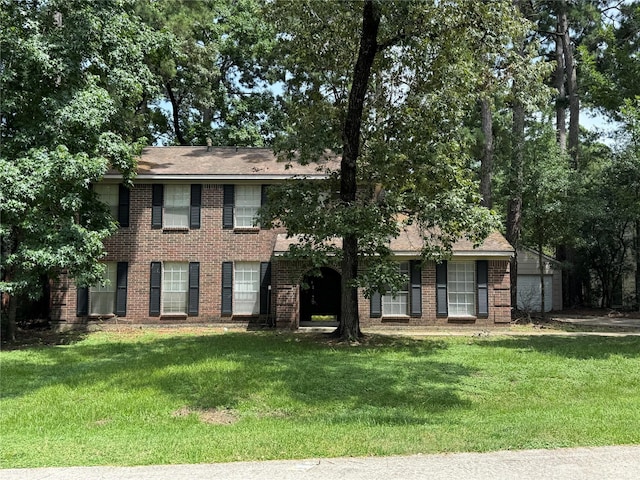 3 Ridgeline Ct, The Woodlands, TX 77381 - view of front facade with brick siding and a front yard
