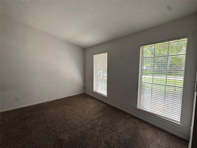 3 Ridgeline Ct, The Woodlands, TX 77381 - carpeted spare room featuring plenty of natural light, vaulted ceiling, and a textured ceiling