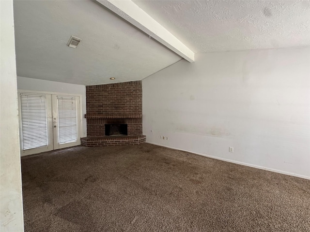 3 Ridgeline Ct, The Woodlands, TX 77381 - unfurnished living room featuring carpet, a textured ceiling, and a fireplace